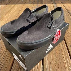 All black Vans Slip-ons